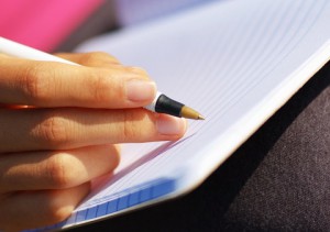 Girl Writing in Note Book